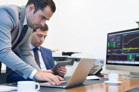 Business team remotely solving a problem at business meeting using laptop ... Stock Photos