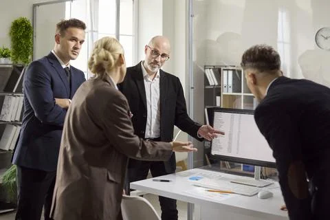 Business team reviewing data on computer during meeting, presenting analytics Stock Photos