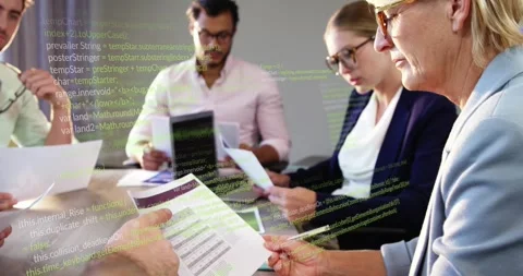 Business team reviewing docs for decision as offframe passing sheet code overlay Stock Footage 329909469