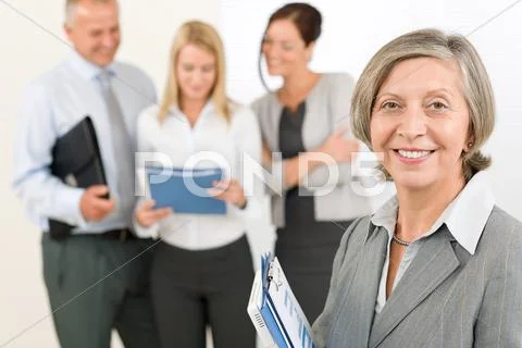 Business team senior woman with happy colleagues Stock Photos