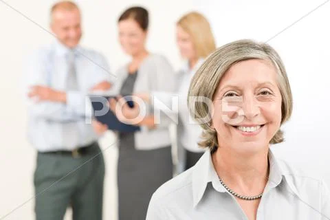 Business team senior woman with happy colleagues Stock Photos