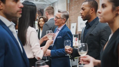 Business Team Socializing At After Works Drinks In Modern Office Stock Footage