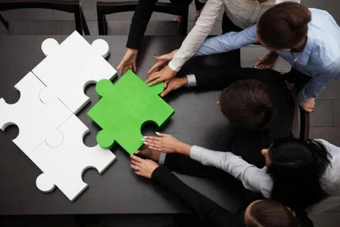Business team solving puzzle Stock Photos