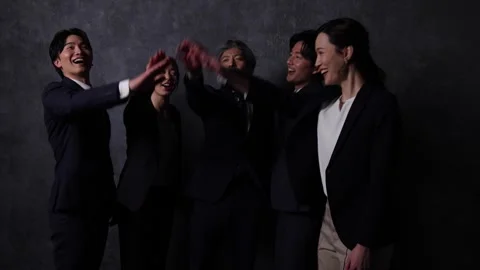 Business Team Stacking Hands Together Showing Teamwork and Unity 動画素材 344081563