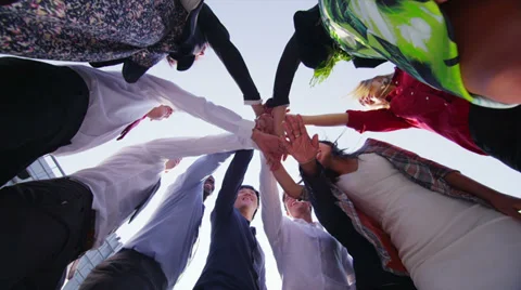 Business team stand in a circle with their hands together for a team talk Stock Footage