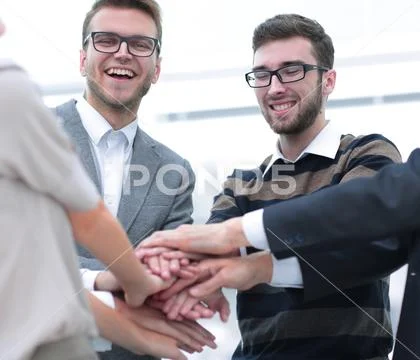 Business team standing joining hands together Stock Photos