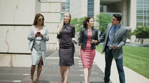 The business team is successfully walking down the street Stock Footage 101852633