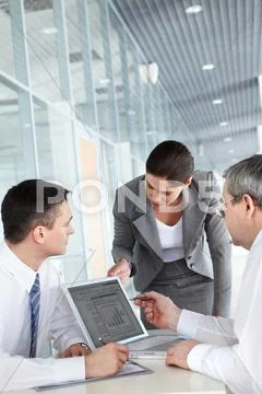 A business team of three planning work in office Stock Photos
