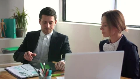 A business team of two sitting in office and check phone Stock Footage 85283482