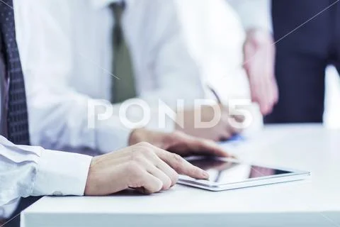 Business team using digital tablet, working with the financial schedule the Stock Photos