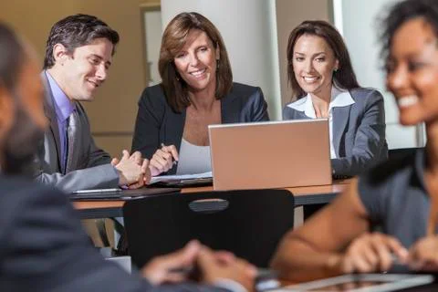 Business team using laptop computer in meeting Stock Photos