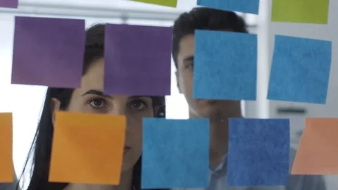 Business team working on a creative project with sticky notes Stock Footage 108421266