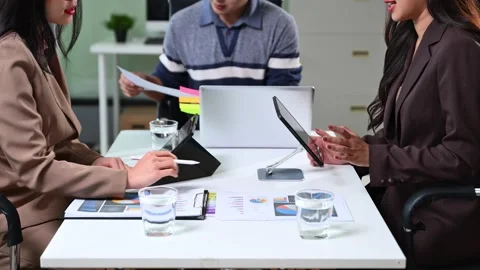 Business team working with digital tablets and reports in a modern office. .. Stock Footage 312439340