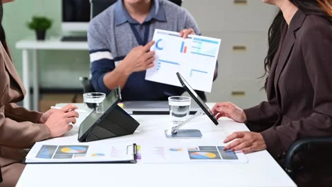 Business team working with digital tablets and reports in a modern office. .. Vídeos de archivo 312439804