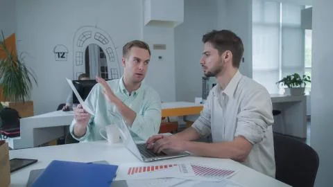 Business team working with paper documents in the modern office Stock Photos