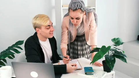 Business, teamwork, office work. Man and a woman colleagues communicate on work Vídeo Stock 149053996