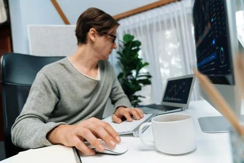 Business trader using computer and laptop to search high profit. Pecuniary. Stock Photos