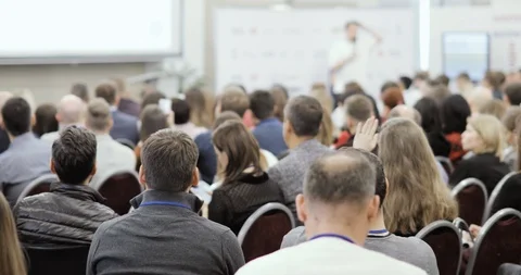 Business training with man speaker talking in large audience, view from viewers. Stock Footage 120256535