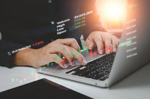 Business using computer laptop and analysing the financial data graph diagram Stock Photos