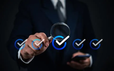 Business verification process with checkmarks and a magnifying glass. Focus.. Stock Photos