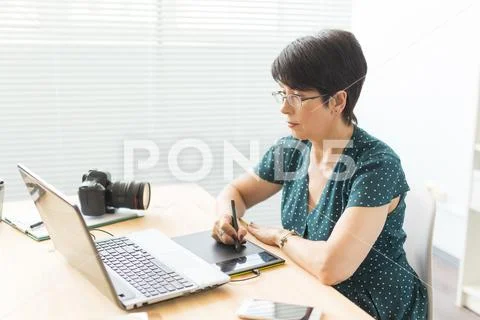 Business, web design and graphic art concept - middle-aged woman using pan Stock Photos