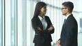 The business woman and a man talk and thumb up in the office hall. slow motion 4k or 4k+ Resolution