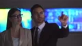 The business woman and a man working with a virtual display 4k or 4k+ Resolution