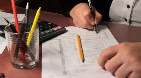 Business woman fills out a 1040 tax form. slider shot. 3. Stock Footage