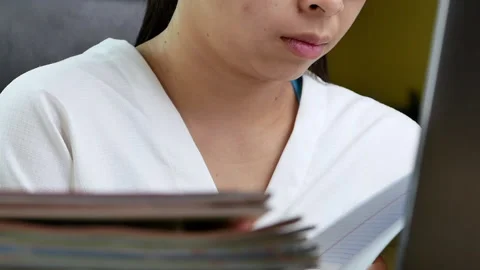 Business woman finding documents while working on laptop at desk. Stock Footage 150418371