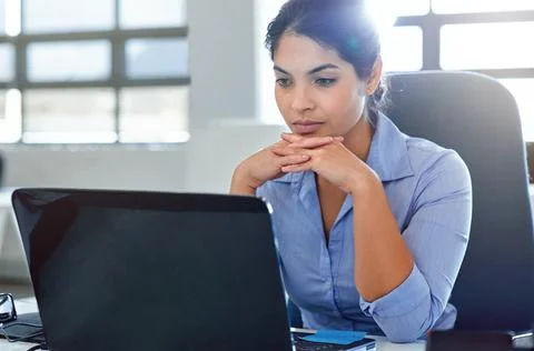 Business woman with laptop, serious and reading with research, email marketing Stock Photos