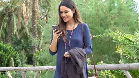 Business Woman in a Park with a Smartphone Stock Footage