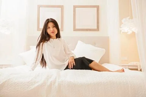 Business woman relaxing on bed at luxury hotel in Iceland Stock Photos