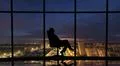 The business woman sits in the office near the windows with a night city view Photo