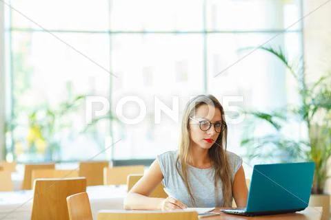 Business woman sitting in a cafe with a laptop Stock Photos