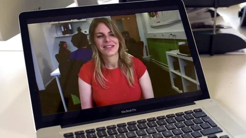 A business woman talks on laptop screen during video conference Stock Footage