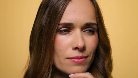 Business woman thinking problem solution. Girl thinking on yellow background Stock Footage 128607635