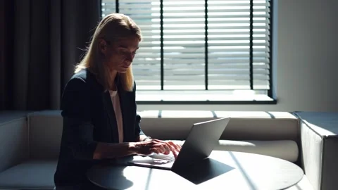 Business woman thinking of problem solution while typing on laptop at office Stock Footage 251816243