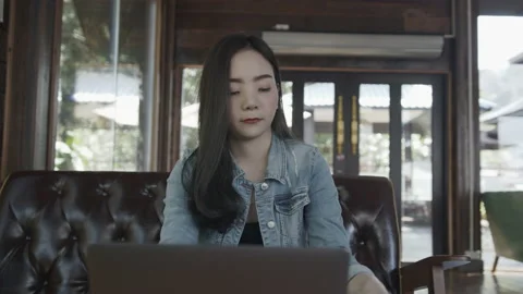 Business woman using laptop computer and drinking coffee in modern cafe. Stock Footage 149388256