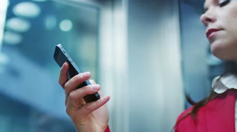 Business Woman using Mobile Phone in Elevator 4K Stock Footage