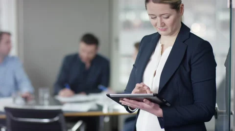 Business woman using tablet computer at business meeting Stock Footage 61359015