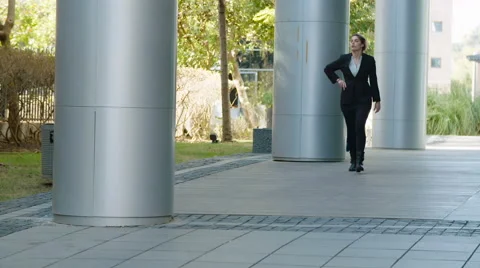 Business woman walking on a street,  talking on a mobile phone Stock Footage 59335563