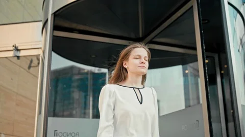 Business Woman in White Shirt is Exiting from Office via Glass Revolving Door Stock Footage