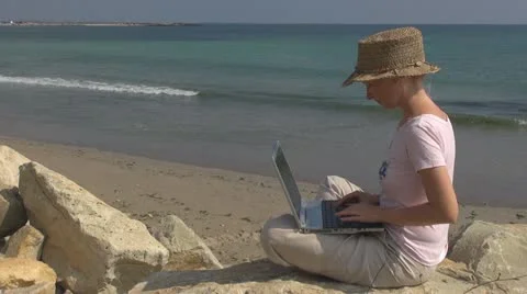 Business woman work on laptop on the beach coastline computer manager holiday Stock Footage