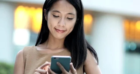 Business woman working on cellphone in the evening Stock Footage