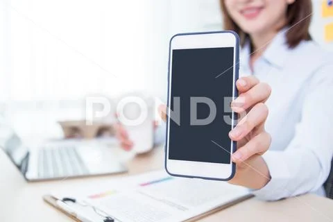 Business woman working at office and showing smart phone Stock Photos