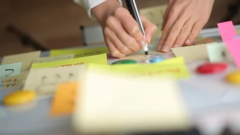 Business woman writes notes using post stickers on paper. Brainstorming Stock-Footage 121000091
