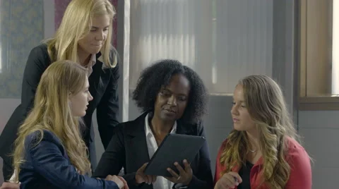 Business women using an ipad/computer tablet in a meeting Stock Footage