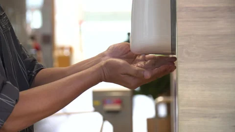 Business worker using alcohol gel disinfecting hands by automatic sanitizer d Stock Footage 138379443