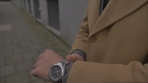 Business young man checking the time on his watch Stock Footage 85667679