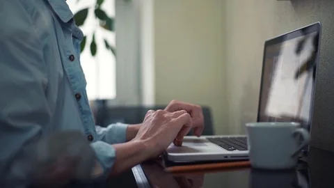 Business young man using laptop scrolling page. Freelancer working at home. Stock Footage 82929109